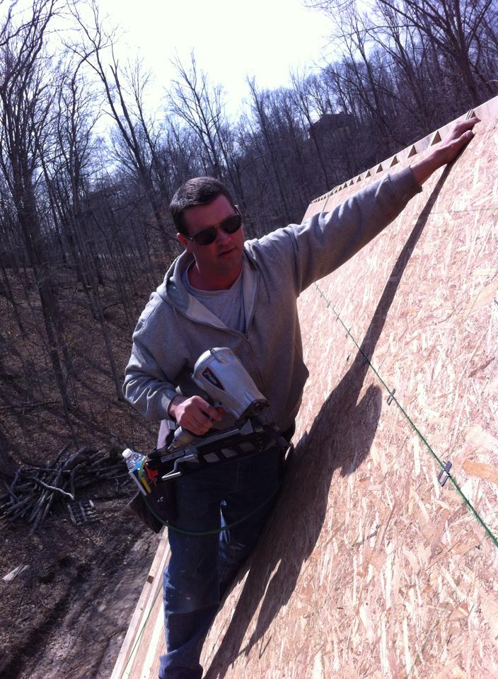 On the roof — nail gun in hand